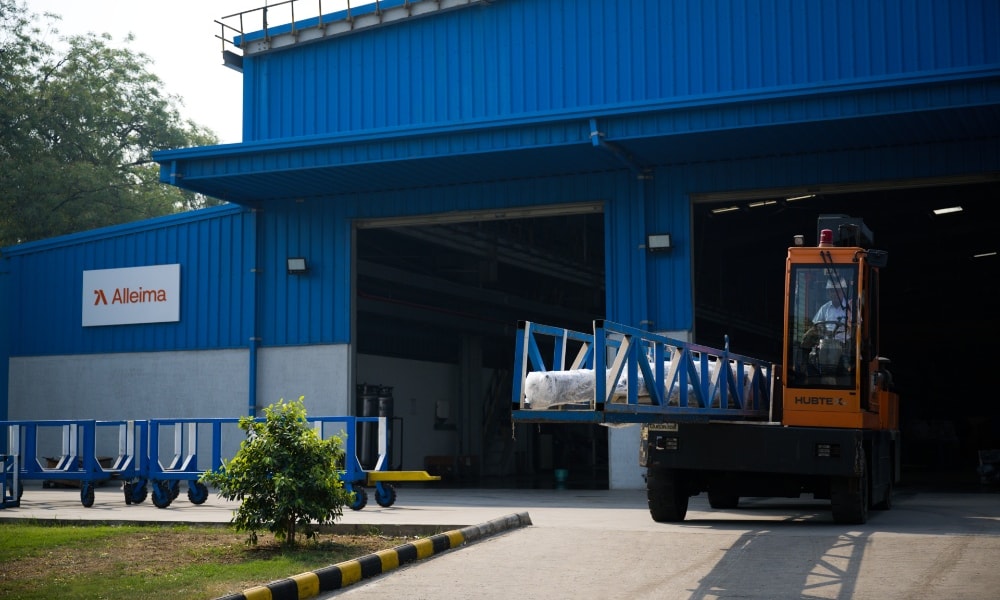 a truck with a blue ladder in front of a blue building