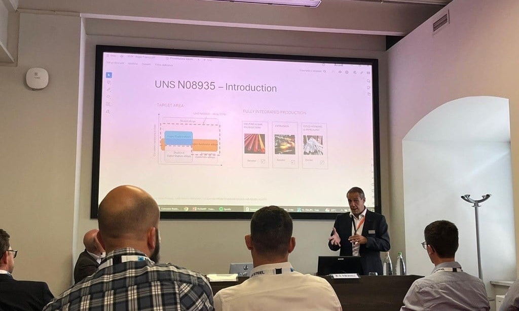 a person standing in front of a large screen