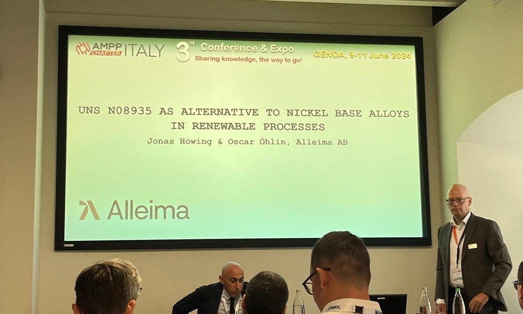 a group of people in front of a screen