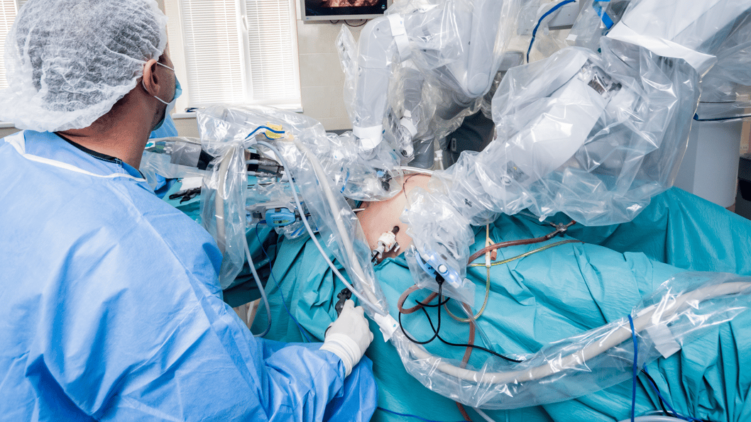 a group of people in surgical gear performing surgery