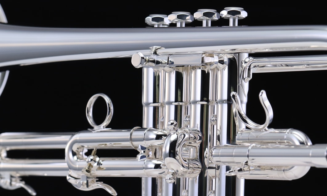 a close up of a silver trumpet