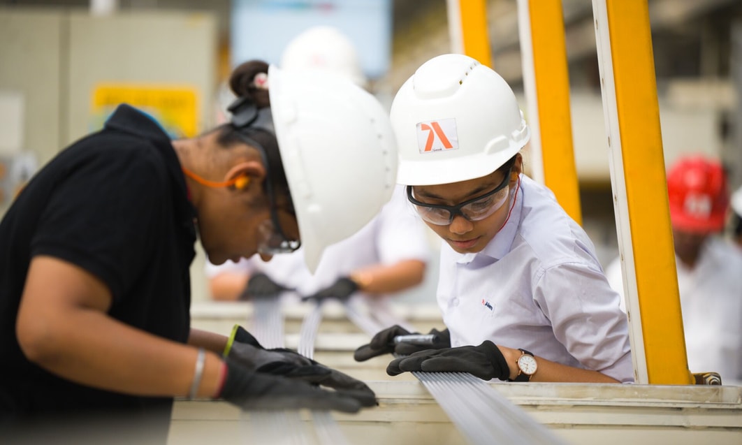 a group of people wearing hard hats and gloves