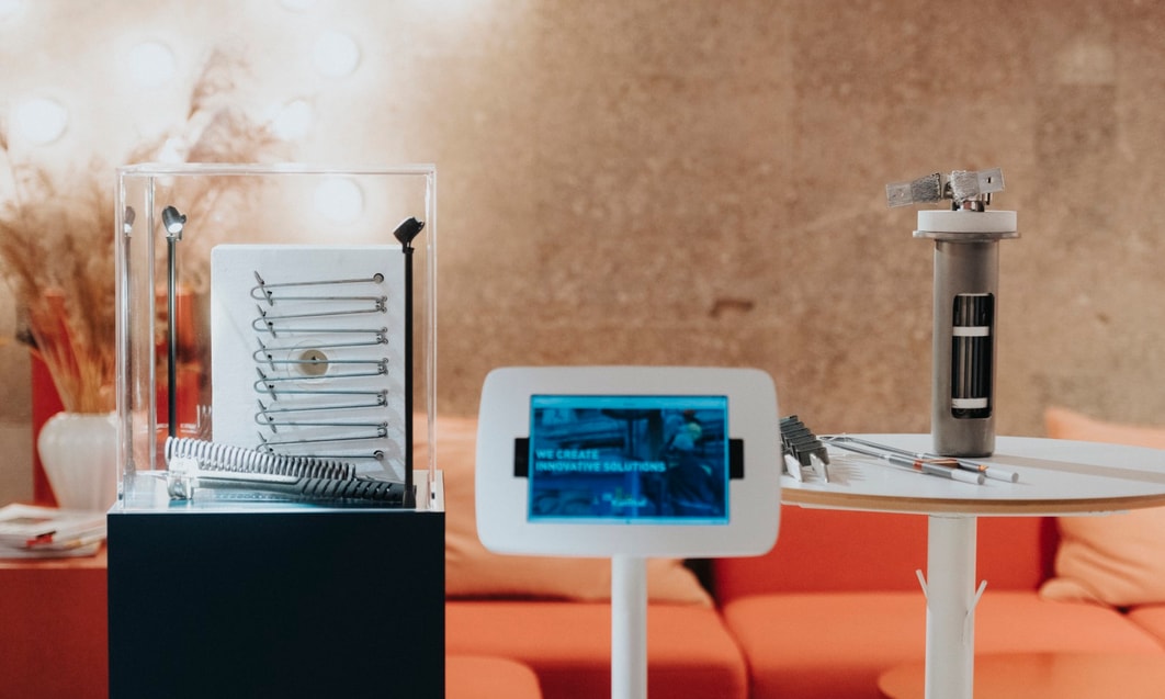 a small white table with a white screen and a white tablet
