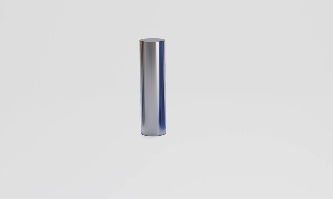 a silver cylinder on a white surface