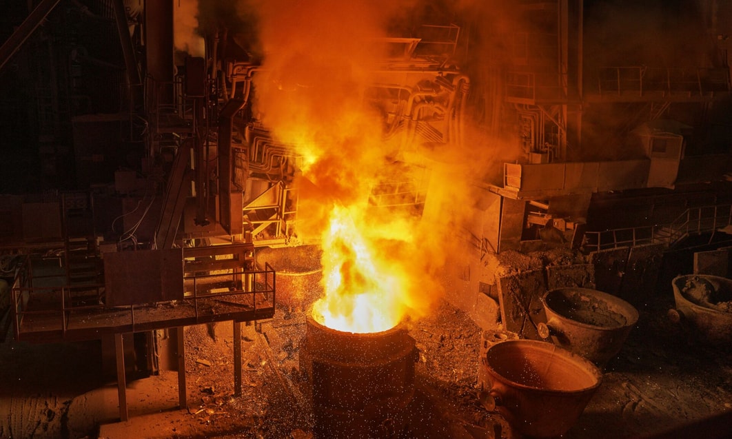 a large metal bucket with fire and smoke