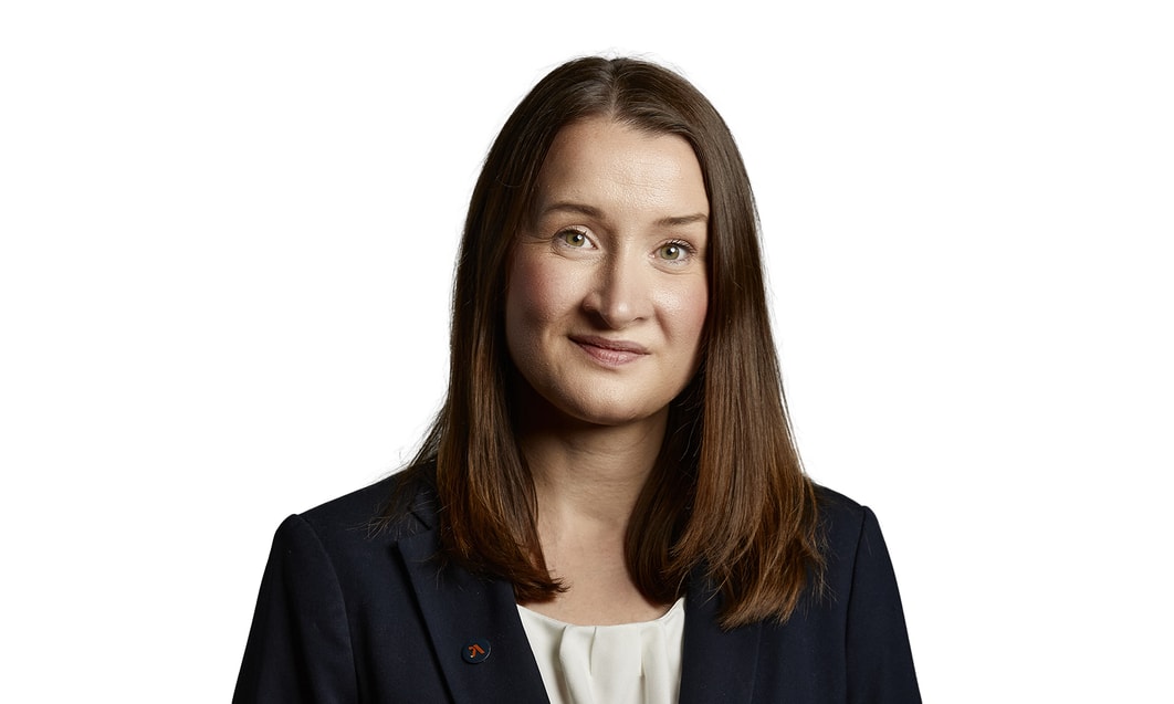 a person with brown hair wearing a suit