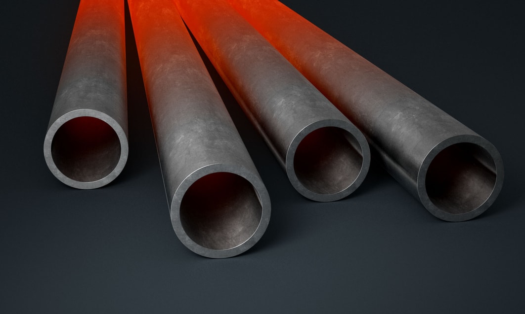 a group of metal pipes with red light