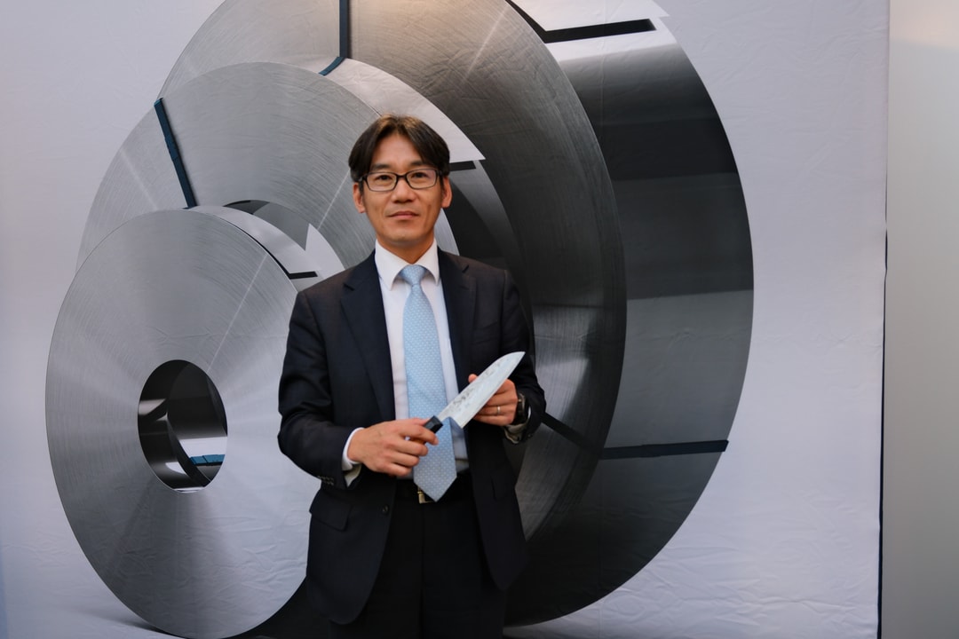 a person in a suit holding a knife