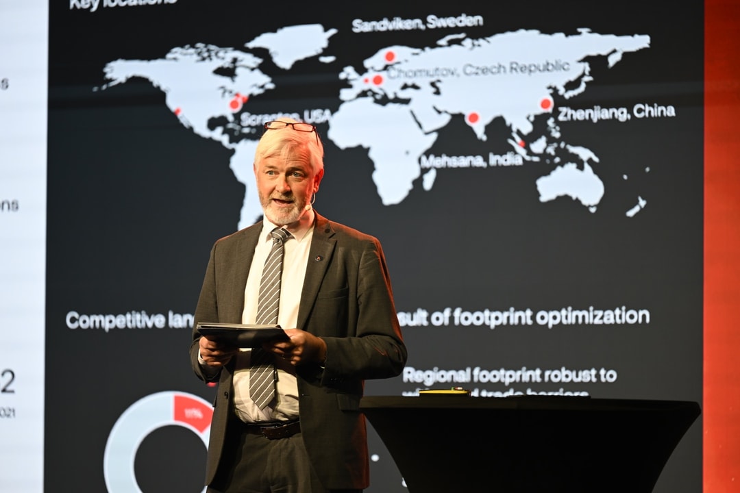 a person standing in front of a world map