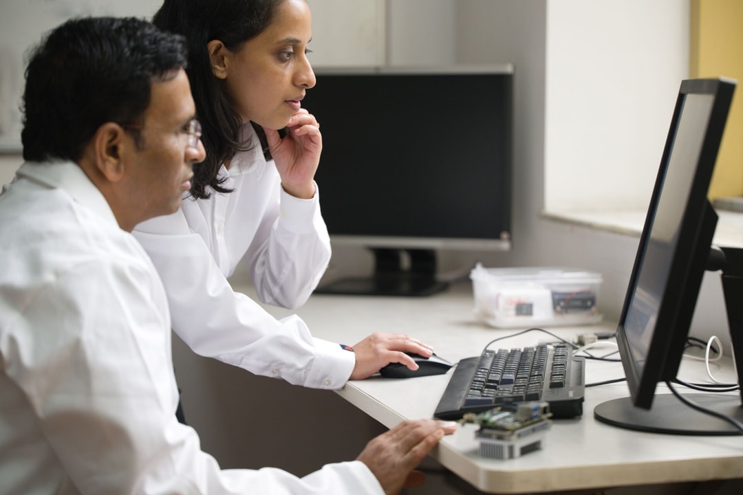 a person and person looking at a computer