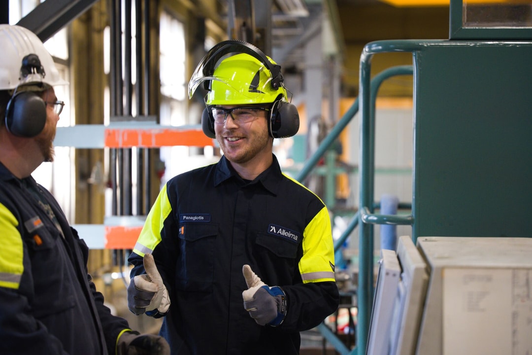 a person wearing a hard hat and gloves