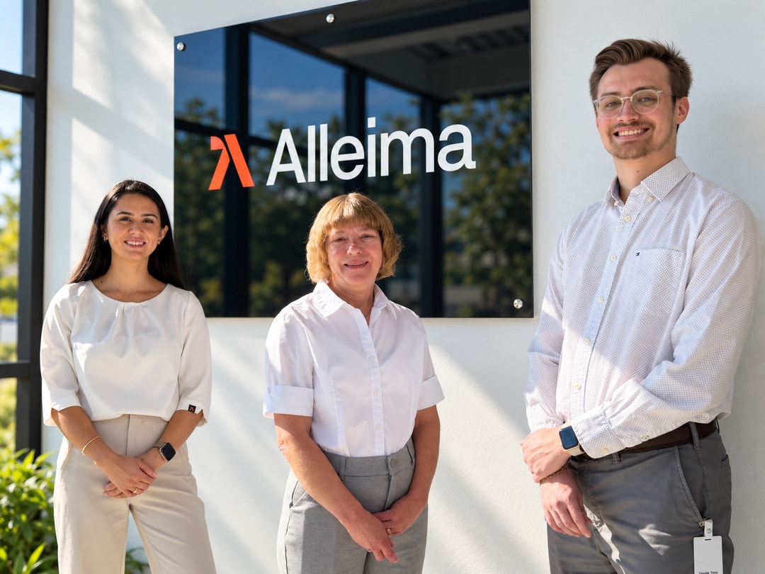 a group of people standing in front of a sign
