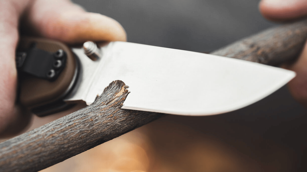 a knife cutting a branch