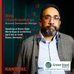 a person wearing glasses and a grey jacket