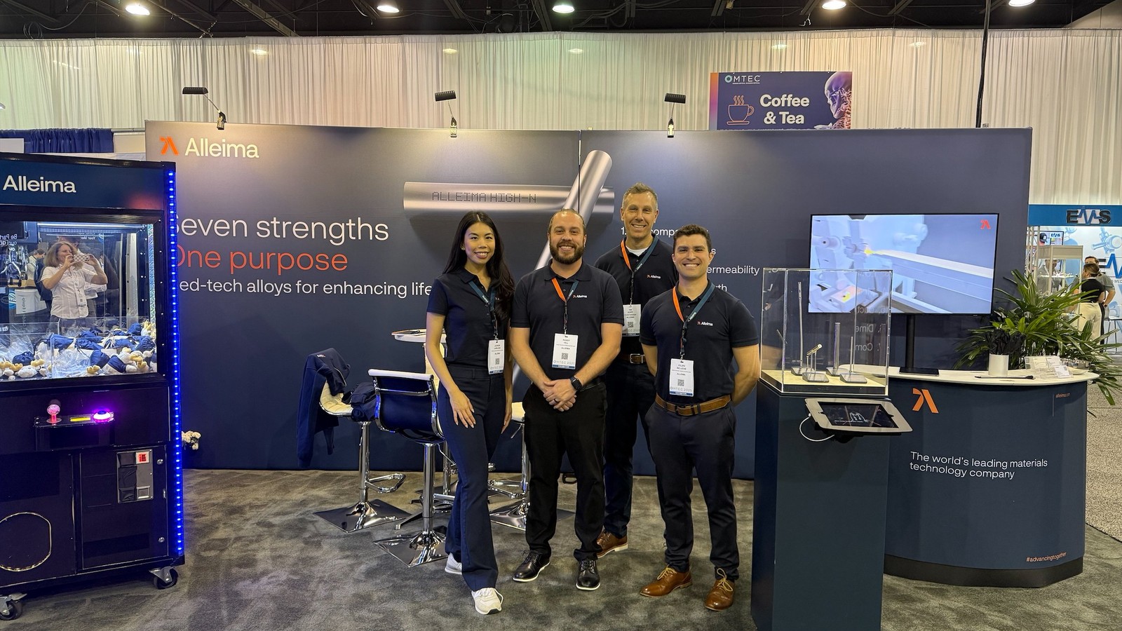 a group of people standing in front of a blue wall