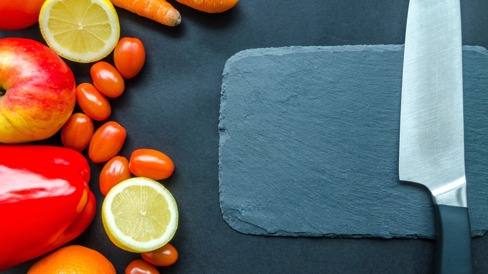 a group of vegetables on a black surface