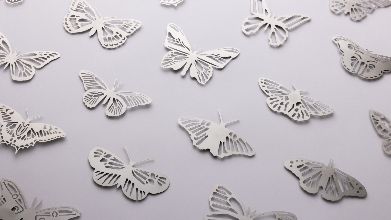 a group of butterflies cut out of paper