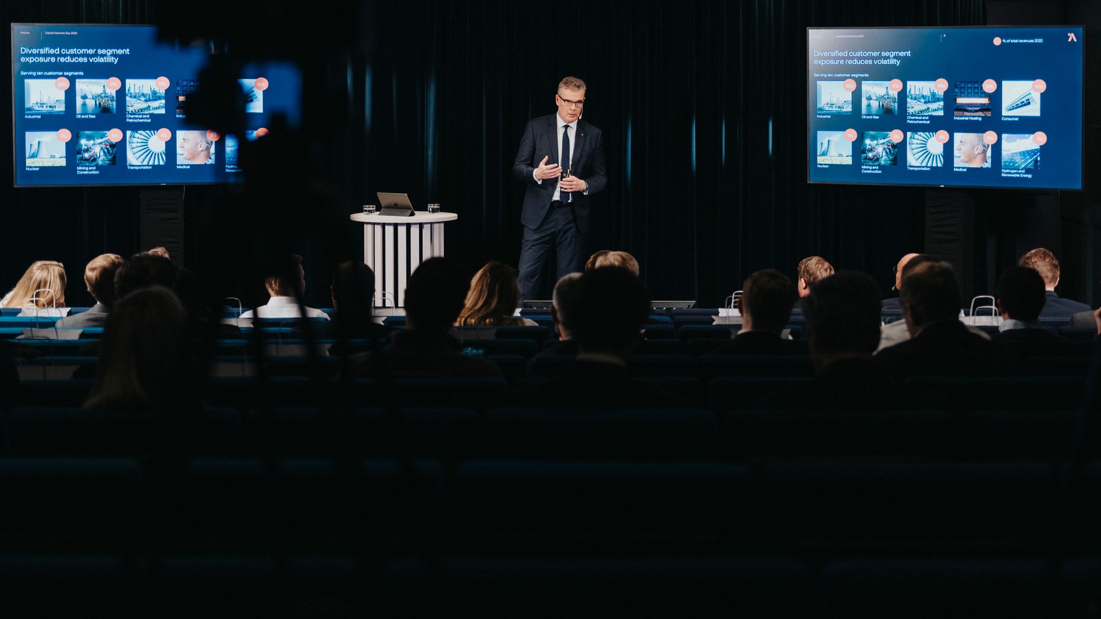 a person standing in front of a crowd of people