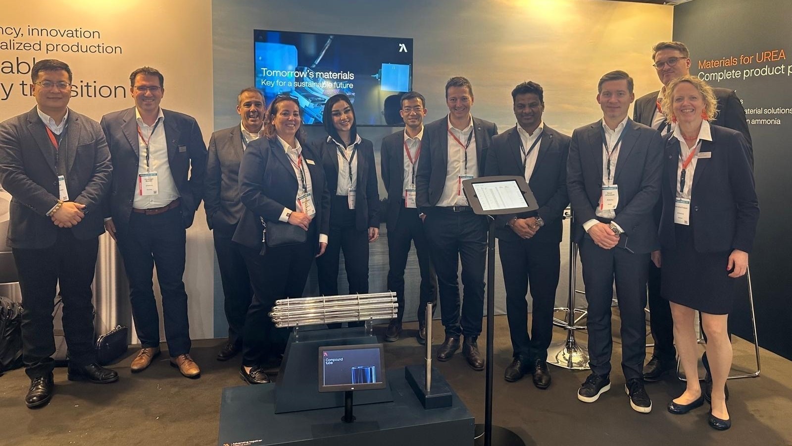 a group of people standing in front of a screen