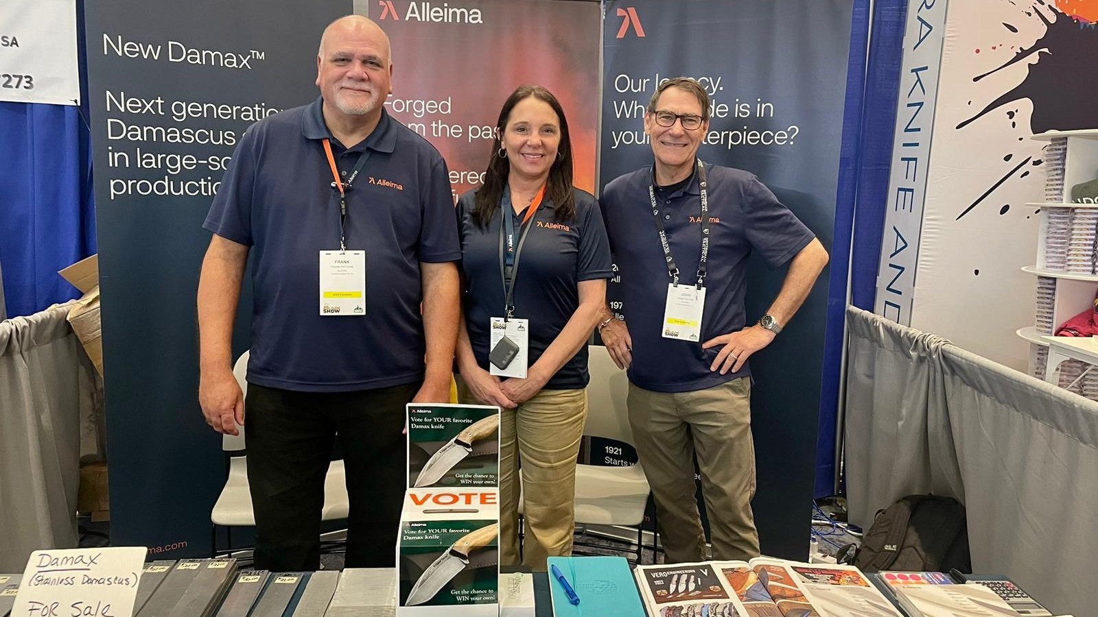 a group of people standing next to a table with knives