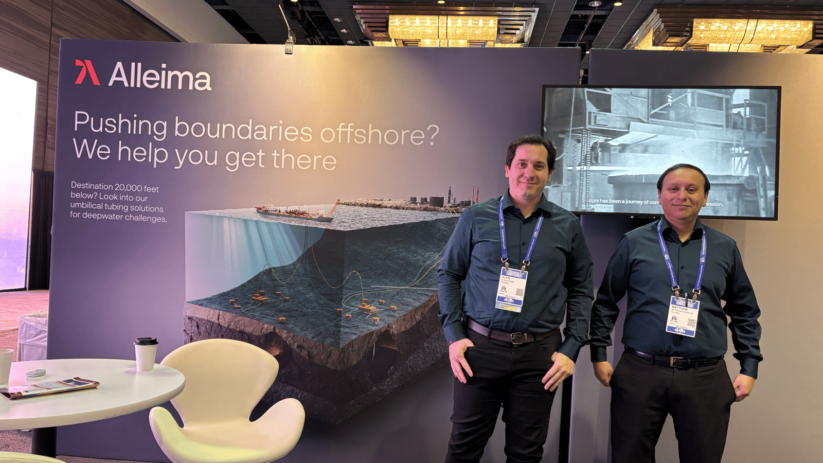 two men standing in front of a sign