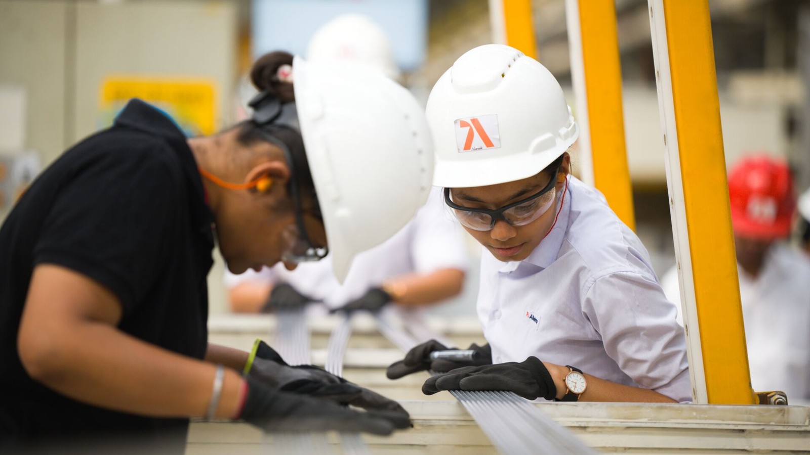 a group of people wearing hard hats and gloves