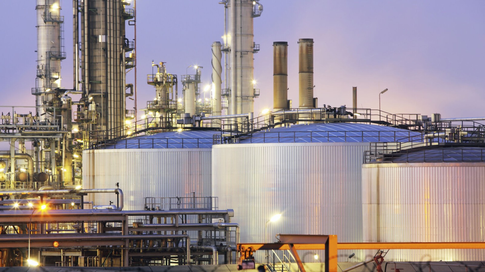 a large industrial plant with towers and lights