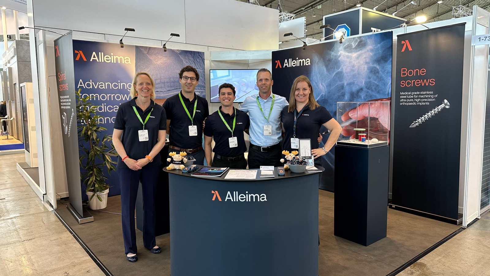 a group of people standing in front of a desk