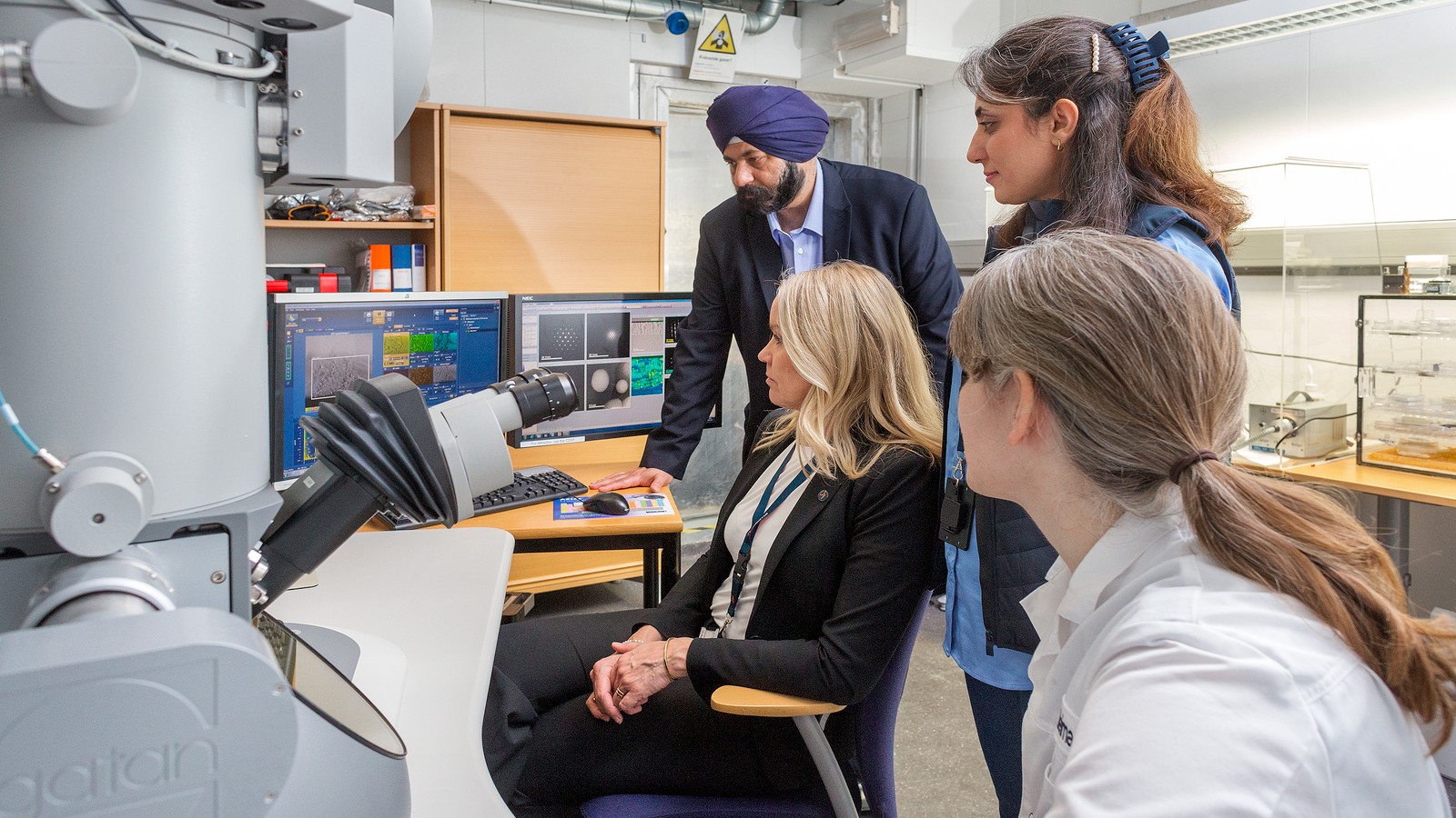 a group of people looking at a computer screen