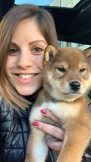 a person holding a puppy