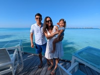 a person and person holding a child on a dock