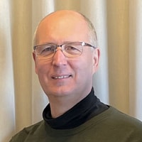 a person wearing glasses and a green shirt