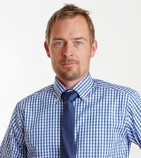 a person wearing a blue and white checkered shirt and tie