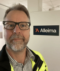 a person wearing glasses and a yellow jacket