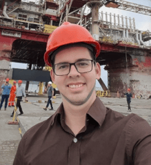 a person wearing a hard hat and glasses
