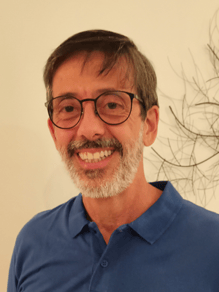 a person wearing glasses and a blue shirt