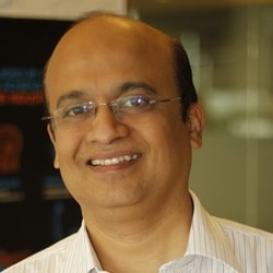 a person wearing glasses smiling