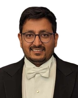 a person in a suit and bow tie