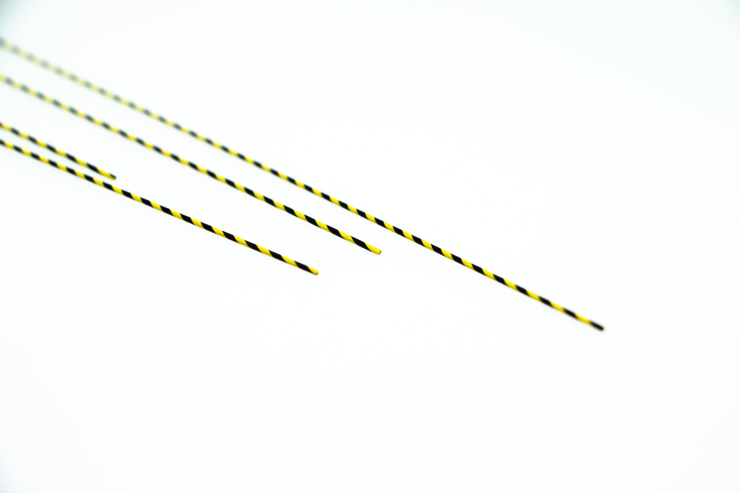 a close-up of a pair of black and yellow striped sticks