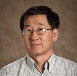 a person wearing glasses and a button up shirt