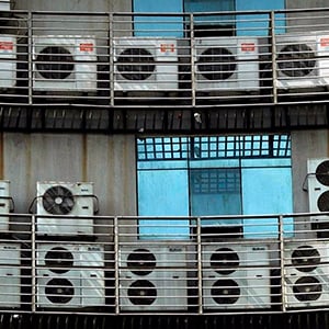 a group of air conditioners on a balcony
