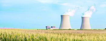 a large white tower with smoke coming out of it