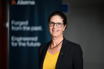 a person in a yellow shirt and black jacket