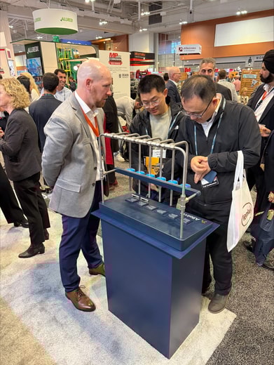 a group of men looking at a machine