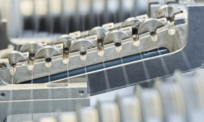 Alleima wire being drawn through a machine