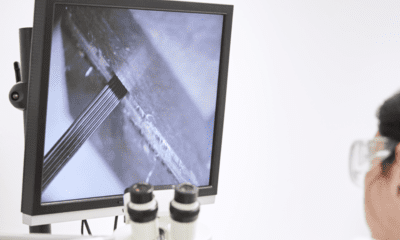 a person in a lab coat looking at a computer screen