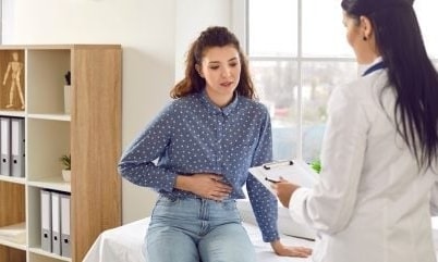 a person sitting on a table with a clipboard