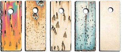several rectangular metal boards with holes
