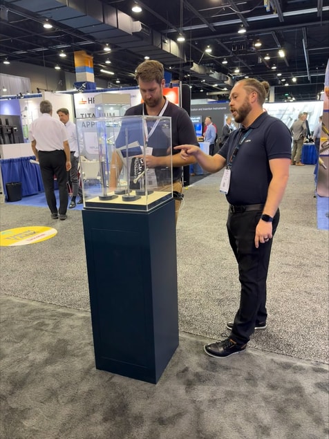 a person standing next to a person in a display case