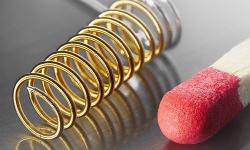 a close-up of a matchstick and a spring